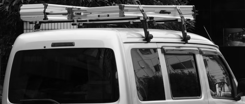 Van with ladders on top